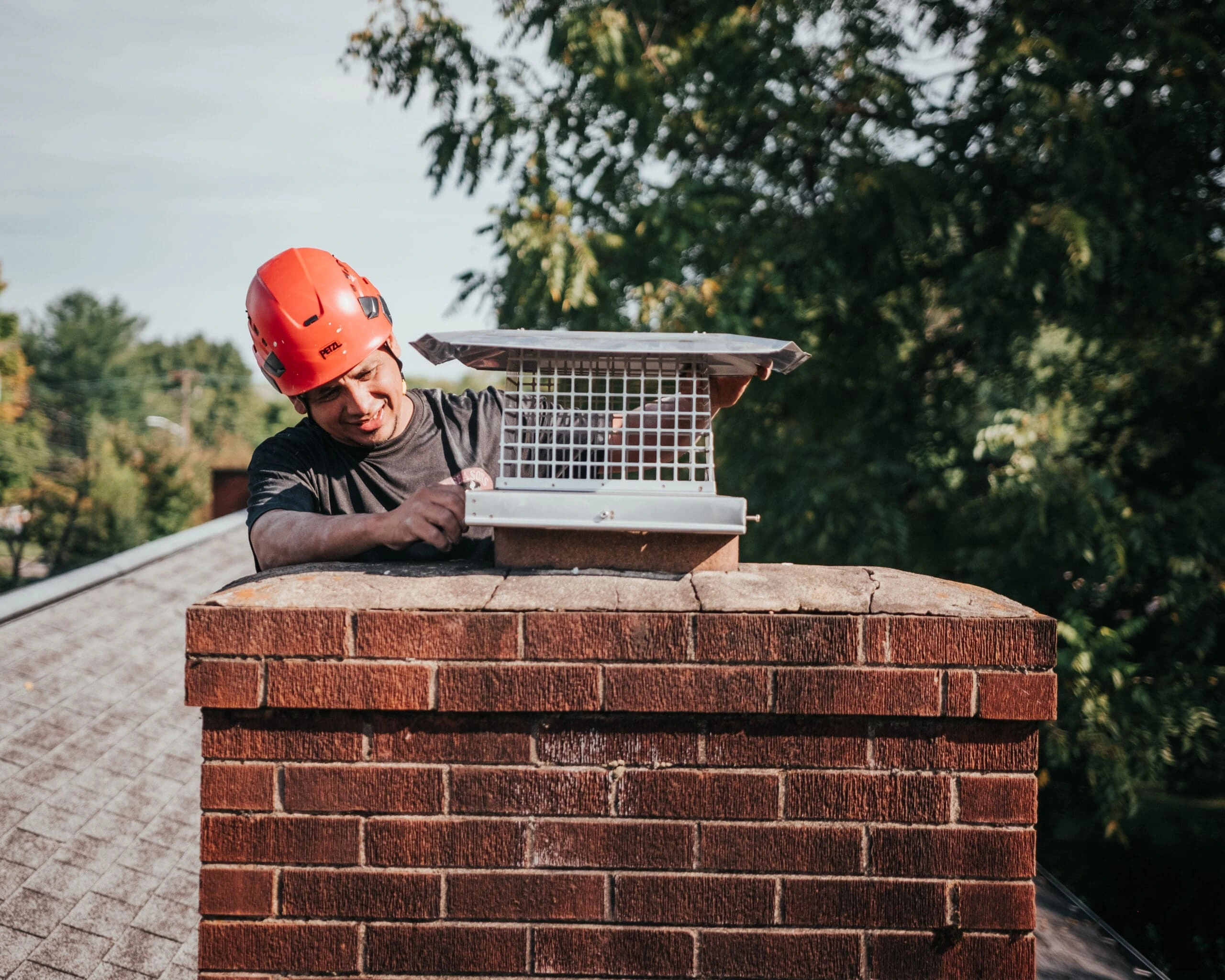 Installation of chimney cap to prevent water damage